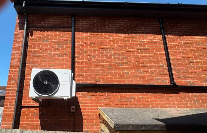 Outdoor air conditioning unit on a brick wall